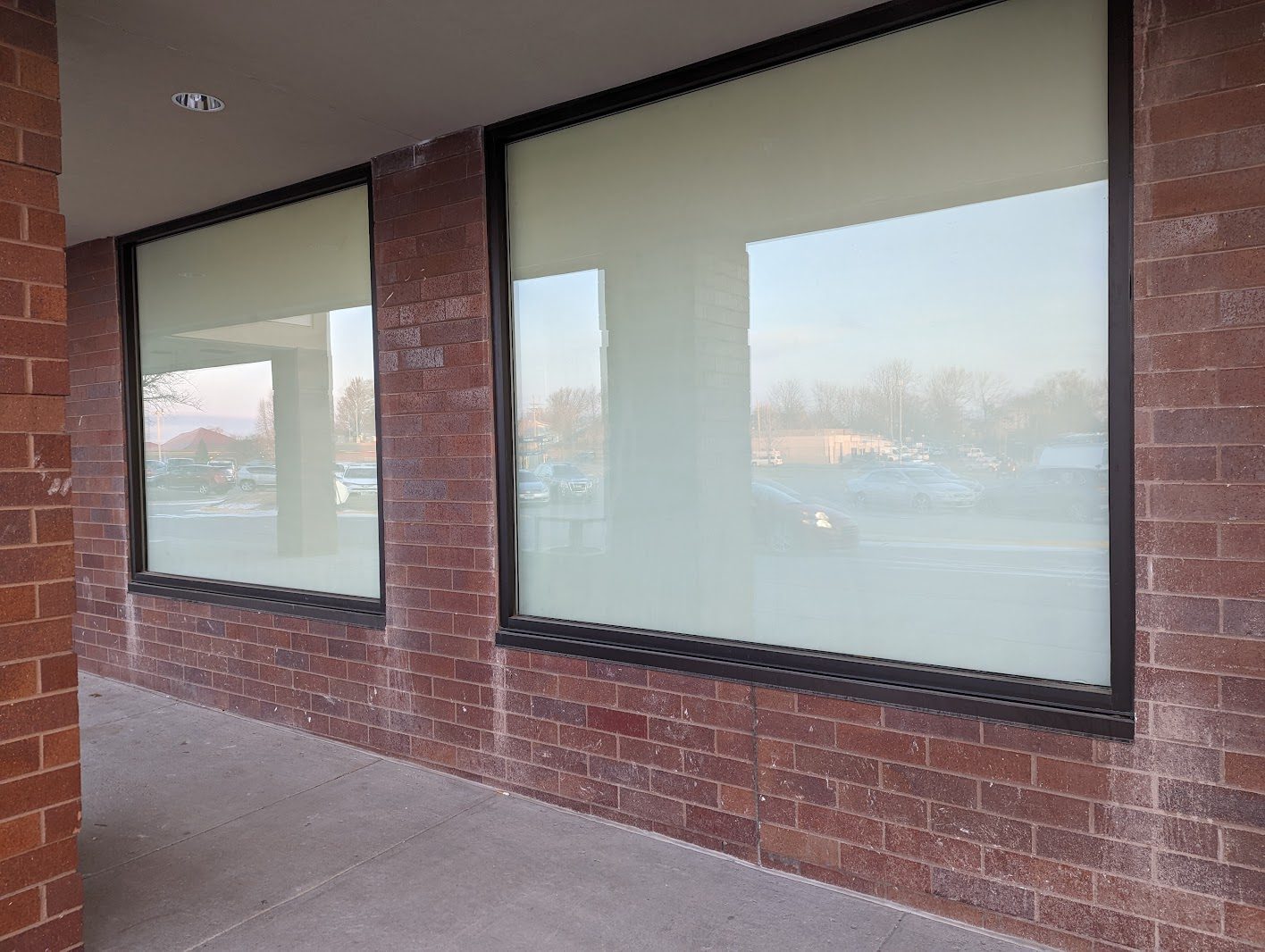 Frosted film on windows of a brick commercial building