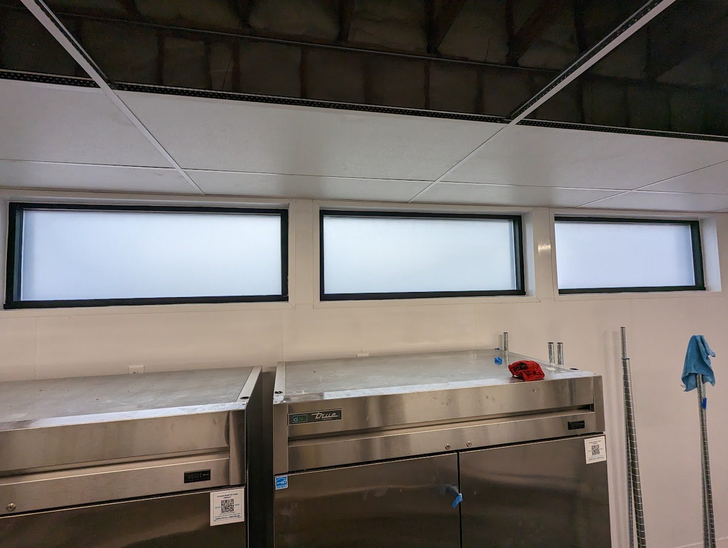Row of frosted windows above stainless counters