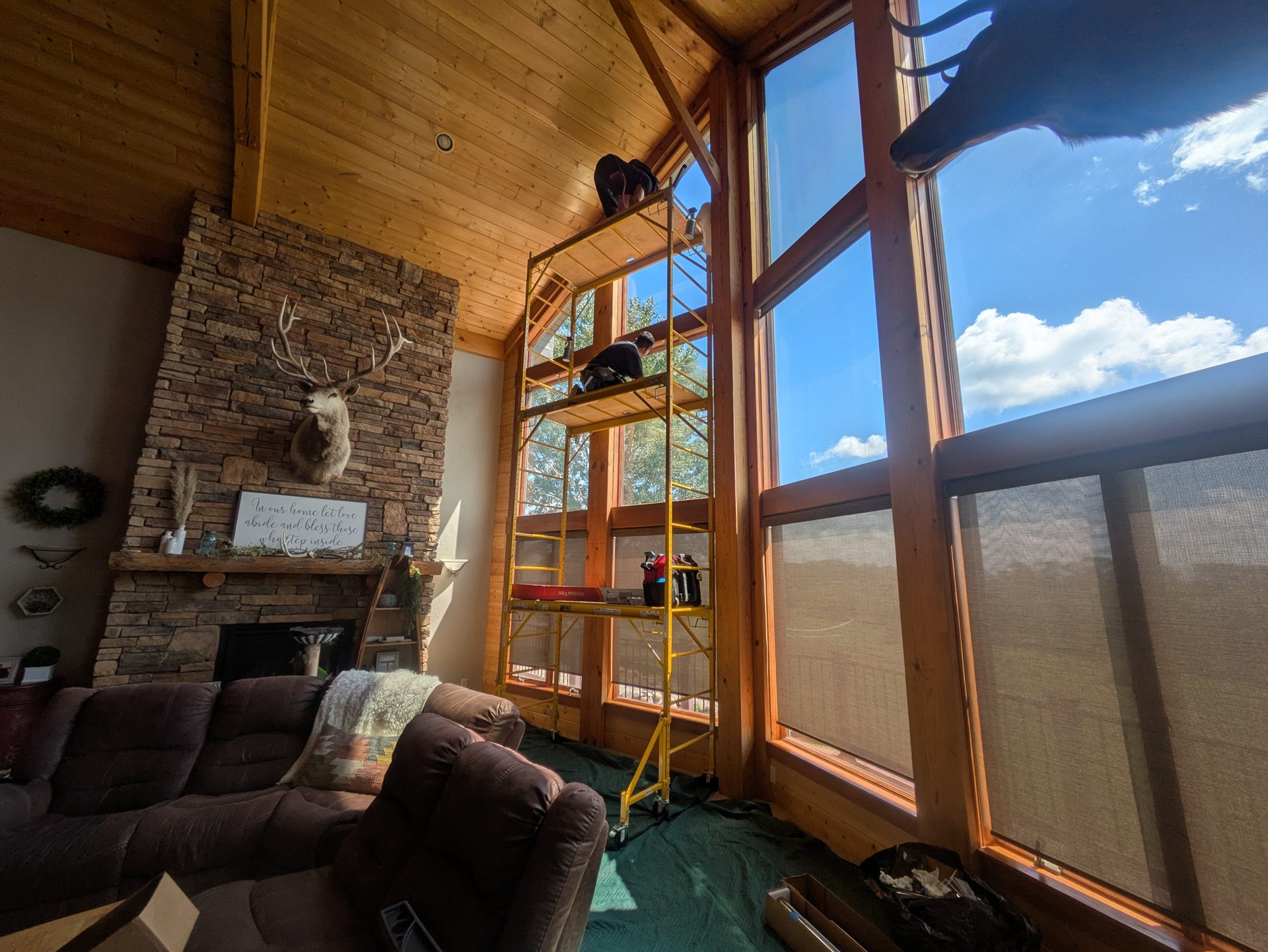 Window film installation in a vaulted great room with three rows of windows