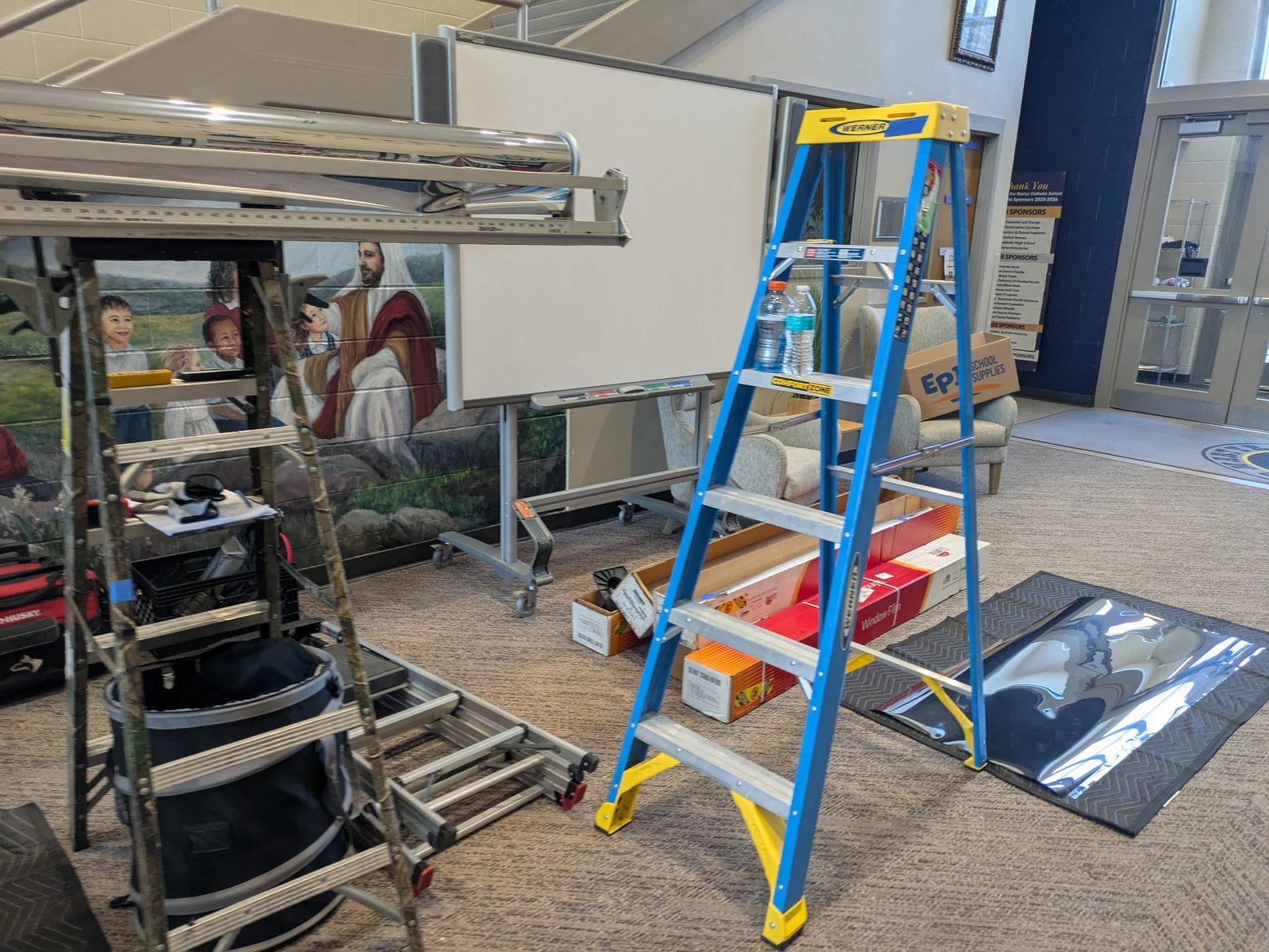Ladders and film installation equipment inside a building