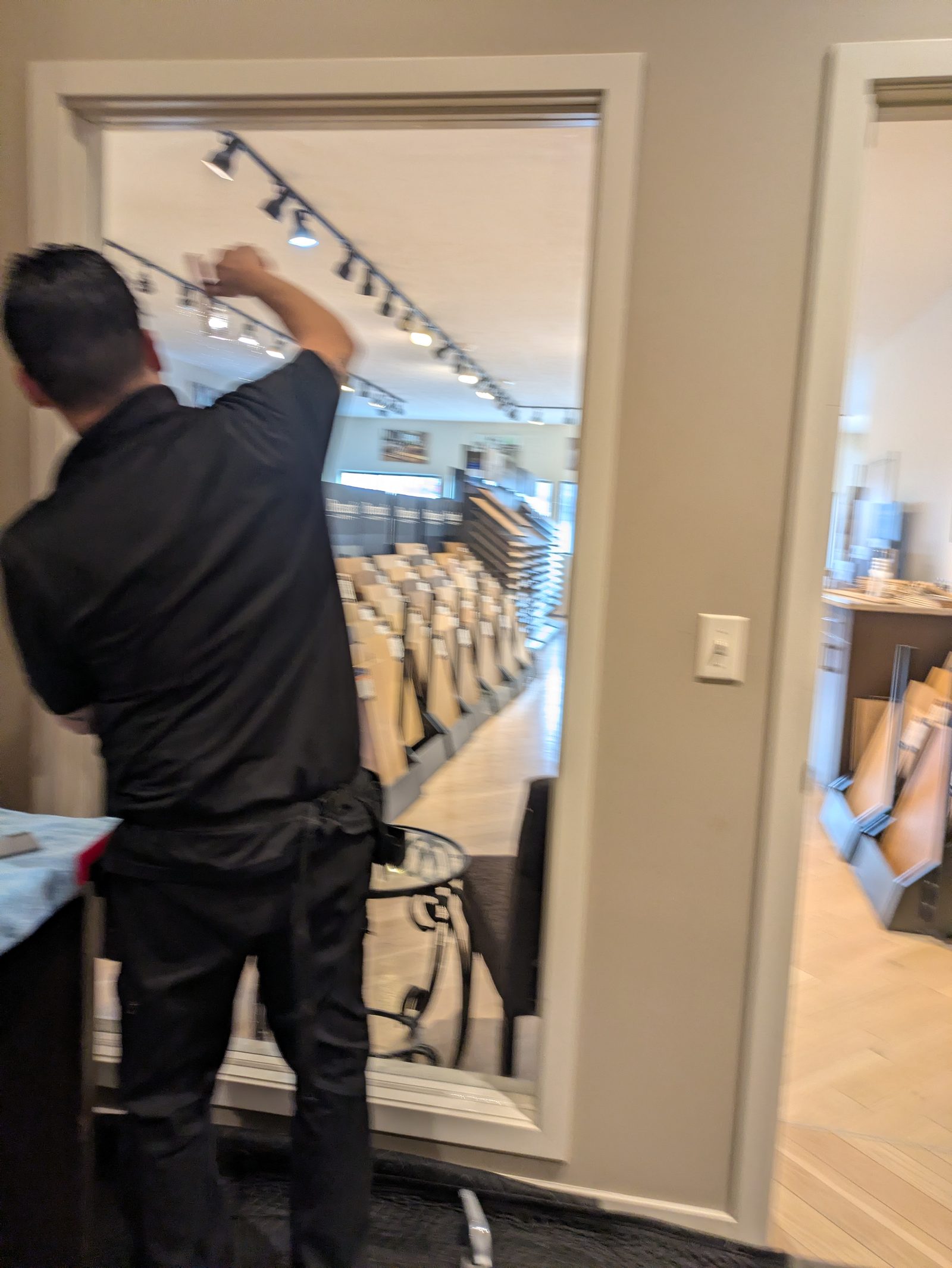 Installer applying film to glass in a retail store