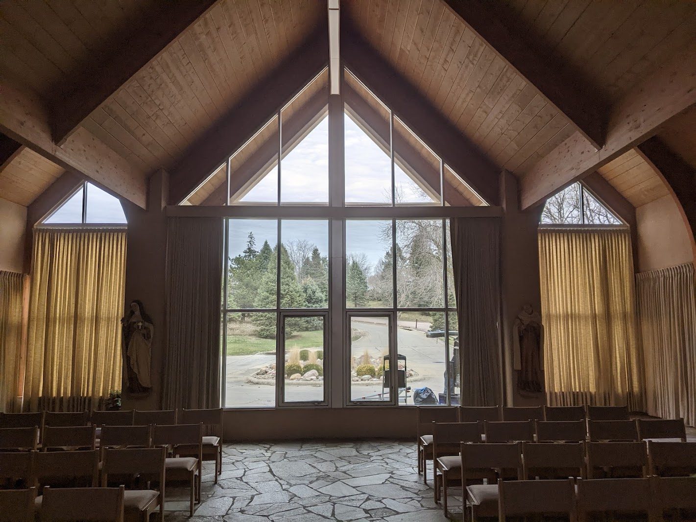 Tall gable windows filling a room with sunlight
